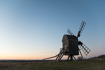 Image showing Old wooden windmill by evening light