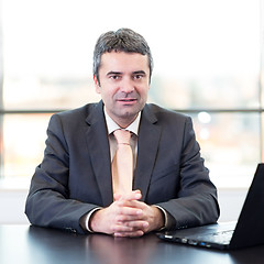 Image showing Portrait of senior businessman in office with laptop computer.