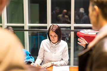 Image showing Personal assistant working at registration desk at corporate event.