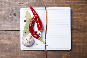 Image showing paper for recipes and spices on wooden table