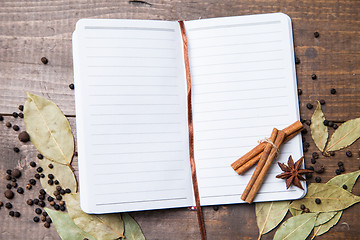 Image showing paper for recipes and spices on wooden table