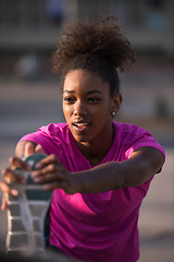 Image showing African American woman doing warming up and stretching