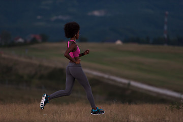 Image showing Young African american woman jogging in nature