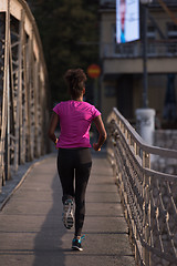 Image showing african american woman running across the bridge