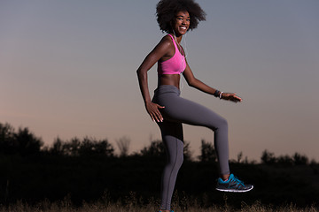 Image showing black woman is doing stretching exercise relaxing and warm up