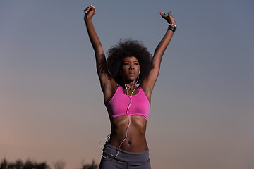 Image showing black woman is doing stretching exercise relaxing and warm up