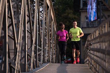 Image showing multiethnic couple jogging in the city