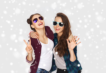 Image showing smiling teenage girls in sunglasses showing peace