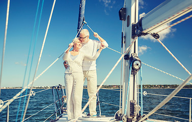 Image showing senior couple hugging on sail boat or yacht in sea