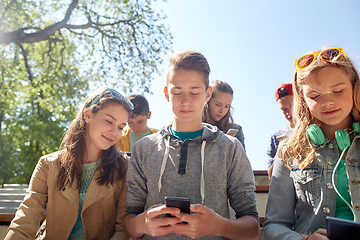 Image showing teenage friends with smartphone and headphones