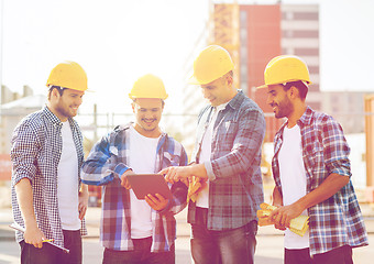 Image showing group of smiling builders with tablet pc outdoors