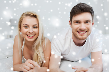 Image showing happy couple lying in bed at home