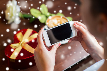 Image showing  hands with smartphone, gift and coffee