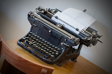 Image showing Old typewriter on a small table