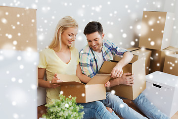 Image showing smiling couple with many boxes moving to new home