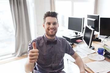 Image showing happy male office worker showing thumbs up