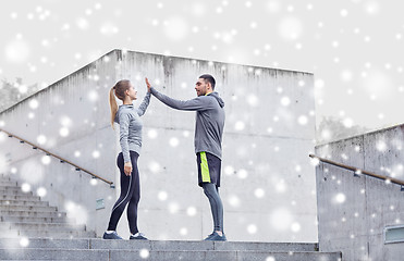 Image showing happy couple of sportsmen making high five