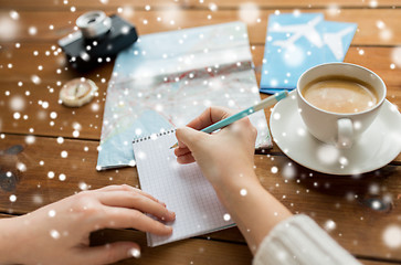 Image showing close up of traveler hands with notepad and pencil