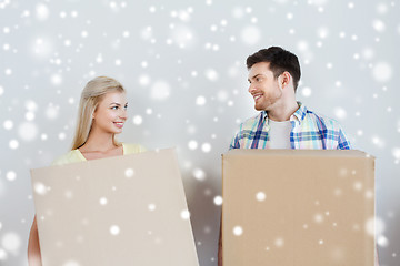 Image showing smiling couple with big boxes moving to new home