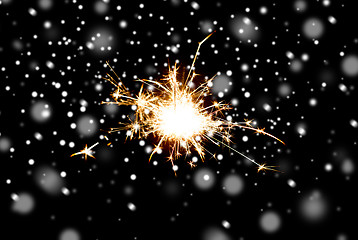 Image showing sparkler or bengal light burning over black