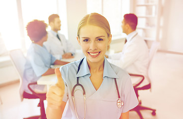 Image showing happy doctor over group of medics at hospital