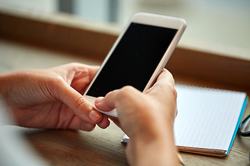 Image showing close up of woman texting on smartphone