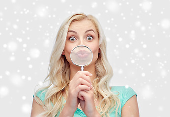 Image showing happy young woman with magnifying glass