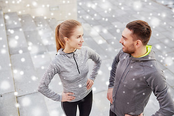 Image showing happy couple of sportsmen outdoors on city street