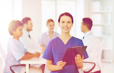 Image showing happy doctor over group of medics at hospital