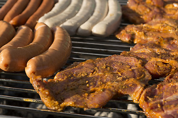 Image showing Meat and sausages on a barbecue grill