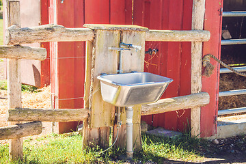 Image showing Steel sink outside a barn