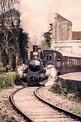Image showing Steamy veteran train driving on a railway