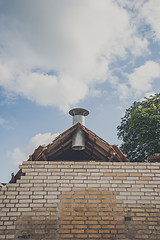 Image showing Steel chimney at a damaged building