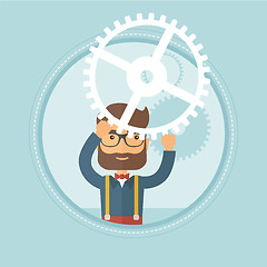 Image showing Businessman holding cogwheel above his head.