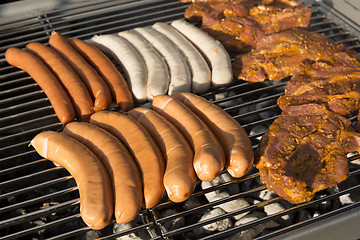 Image showing Meat and sausages on a barbecue grill