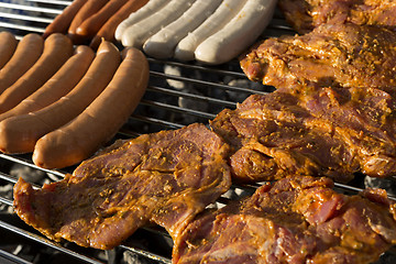 Image showing Meat and sausages on a barbecue grill