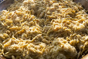Image showing Golden potato dumplings with sauerkraut in a big pan
