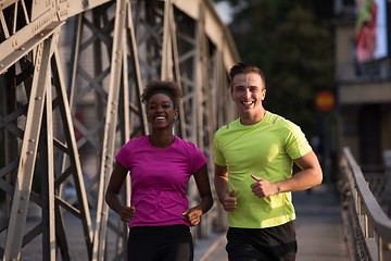 Image showing multiethnic couple jogging in the city