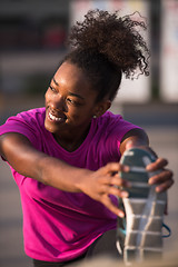 Image showing African American woman doing warming up and stretching