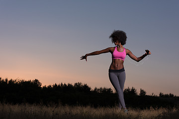 Image showing black woman is doing stretching exercise relaxing and warm up