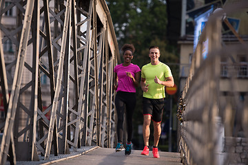 Image showing multiethnic couple jogging in the city