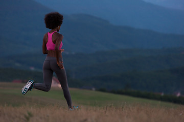 Image showing Young African american woman jogging in nature