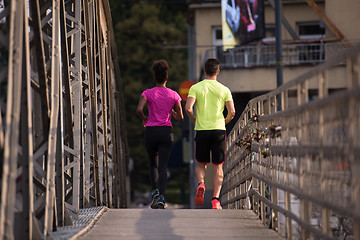 Image showing multiethnic couple jogging in the city