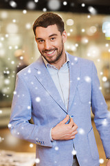 Image showing happy young man in jacket at clothing store