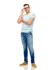 Image showing smiling young man in eyeglasses over white