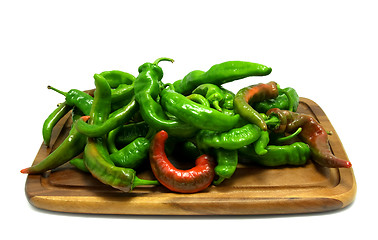 Image showing Multicolor hot peppers on wooden kitchen board