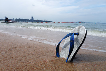 Image showing Beach slippers on a sandy beach