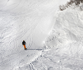 Image showing Skier on ski slope at sun winter day