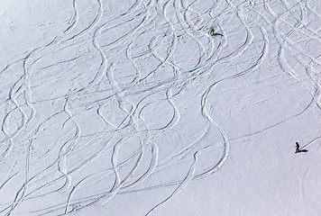 Image showing Snowboarders and skiers on off piste slope