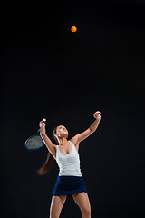 Image showing Portrait of beautiful girl tennis player with a racket on dark background